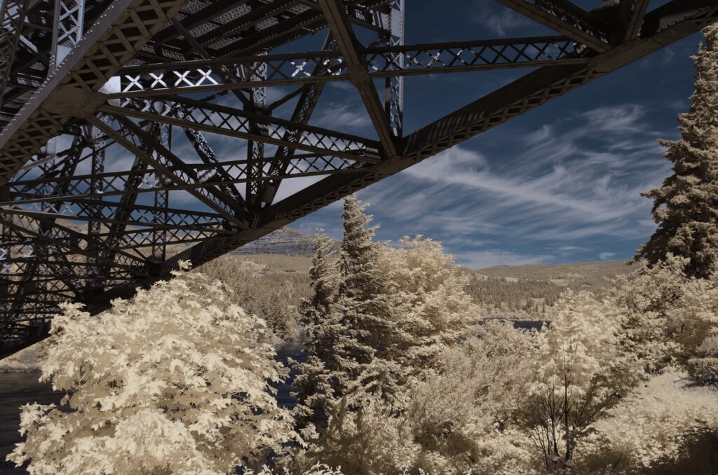 diagonal shot of a steel bridge above on the Colombia Gorge river taken in infrared